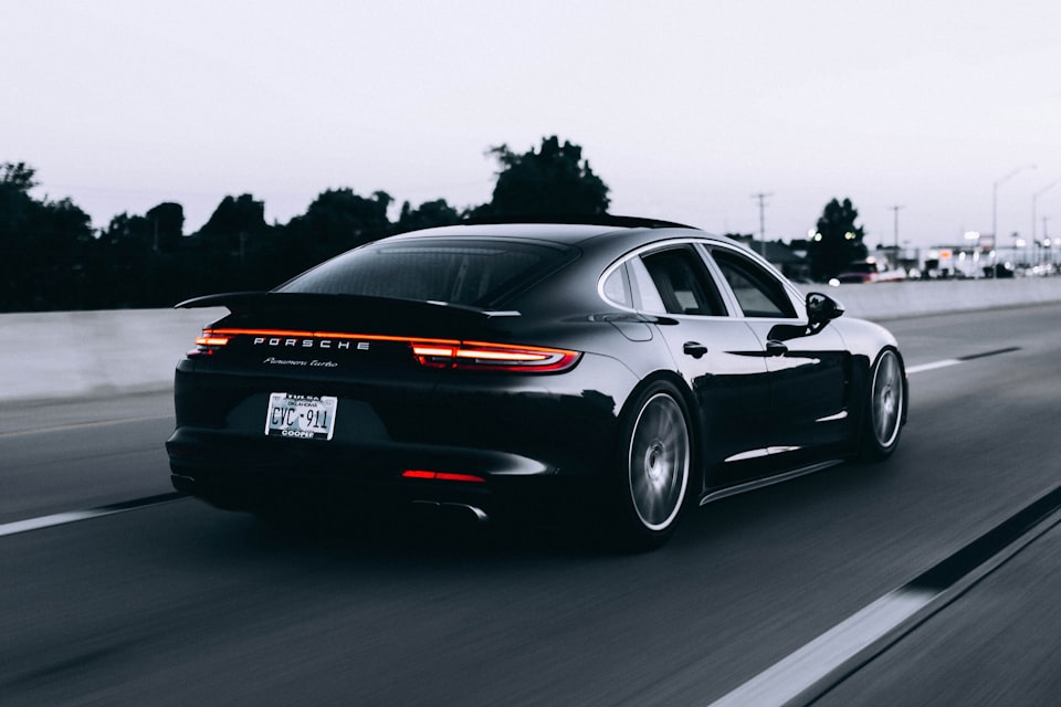 Sleek Porsche sports car showcasing aerodynamic body kit and rear spoiler